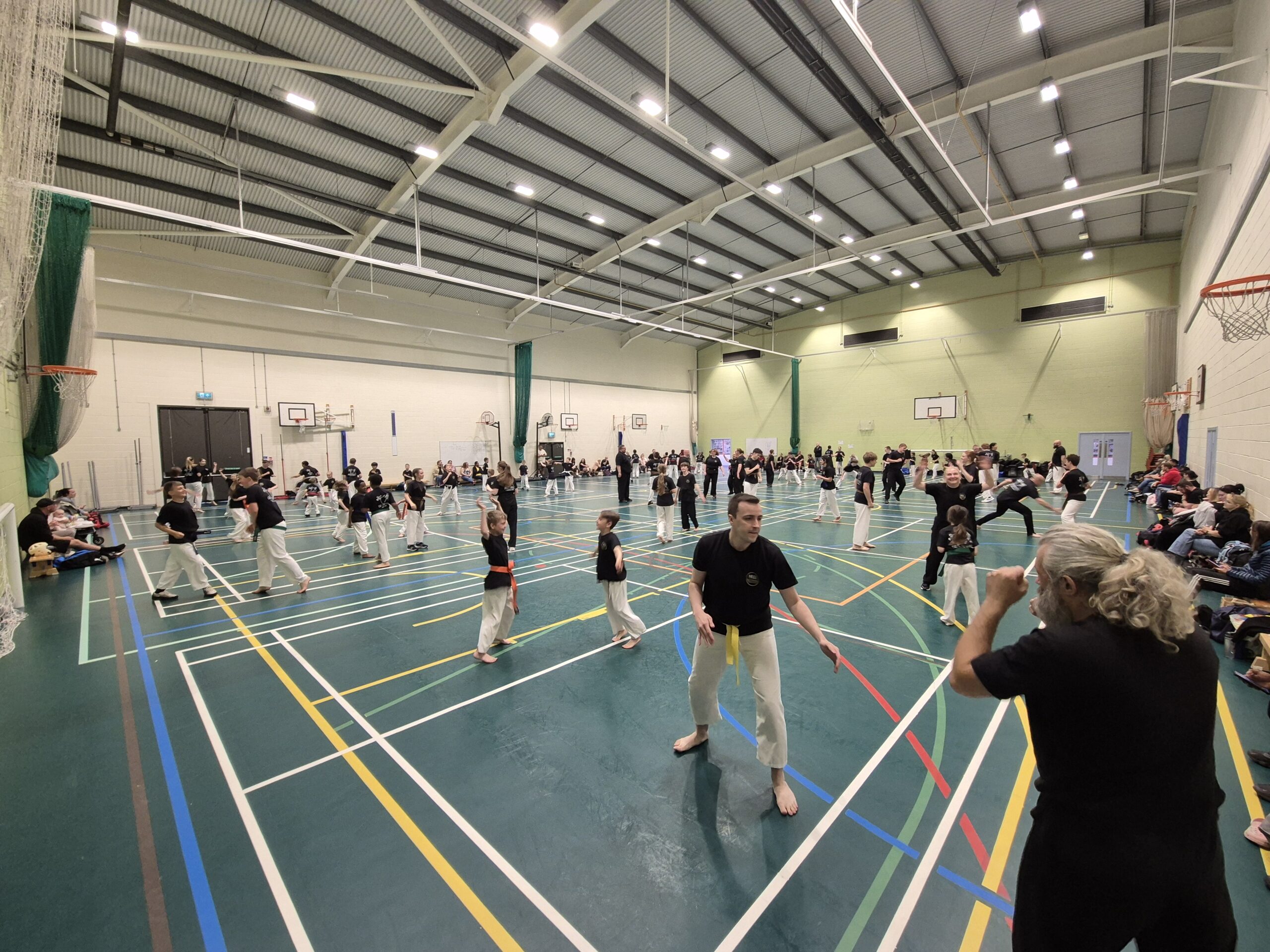 A sports hall full of EUMA students warming up